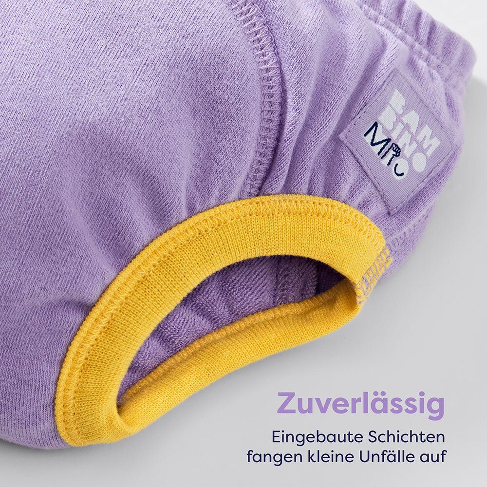 Lila Lernhöschen mit gelben Rändern. Text: Zuverlässig. Eingebaute Schichten fangen kleine Unfälle auf.