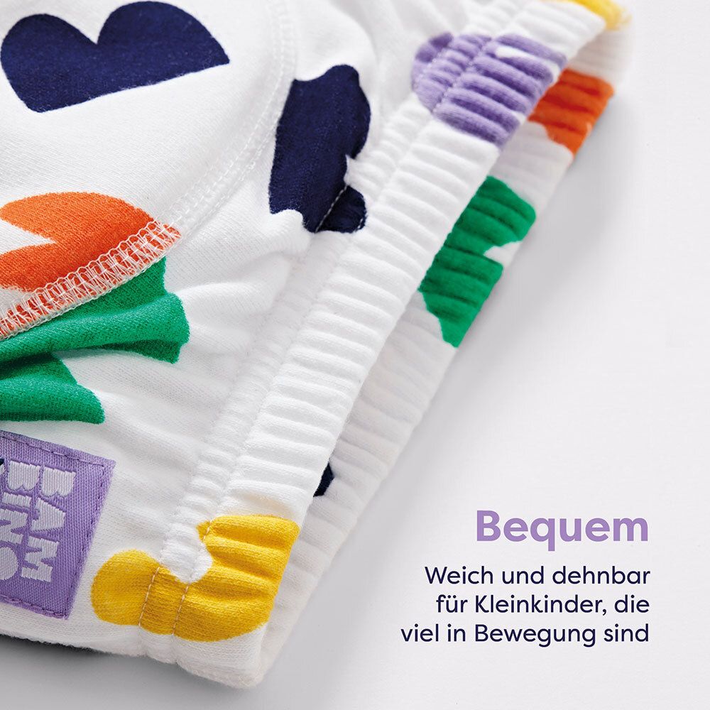 Weiße Lernhöschen mit bunten Formen. Text: Bequem. Weich und dehnbar für Kleinkinder.