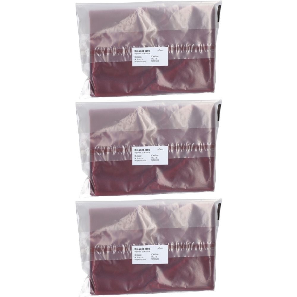 Drei Kissenbezüge in Folienverpackung. Bordeauxfarbenes Samtmaterial. Etikett mit Produktinformationen.