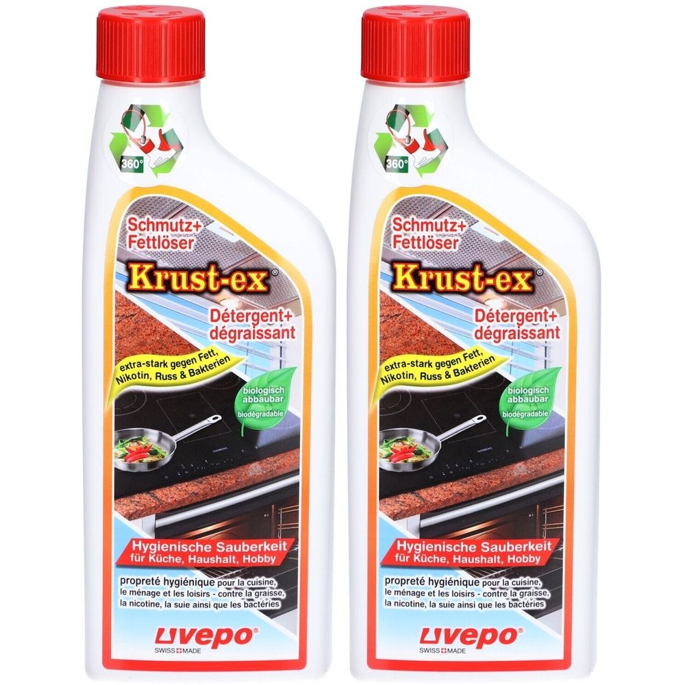 Zwei weiße Flaschen mit rotem Deckel. Aufschrift: Krust-ex, Schmutz+Fettlöser. Hygienische Sauberkeit für Küche, Haushalt, Hobby.