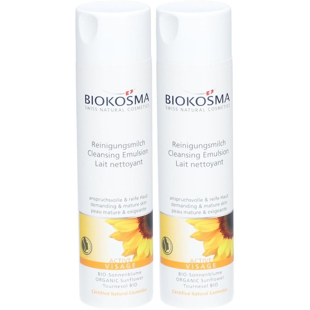 Deux flacons de lait nettoyant Biokosma. Flacons blancs avec étiquette jaune et motif tournesol. Texte: Reinigungsmilch, Cleansing Emulsion.