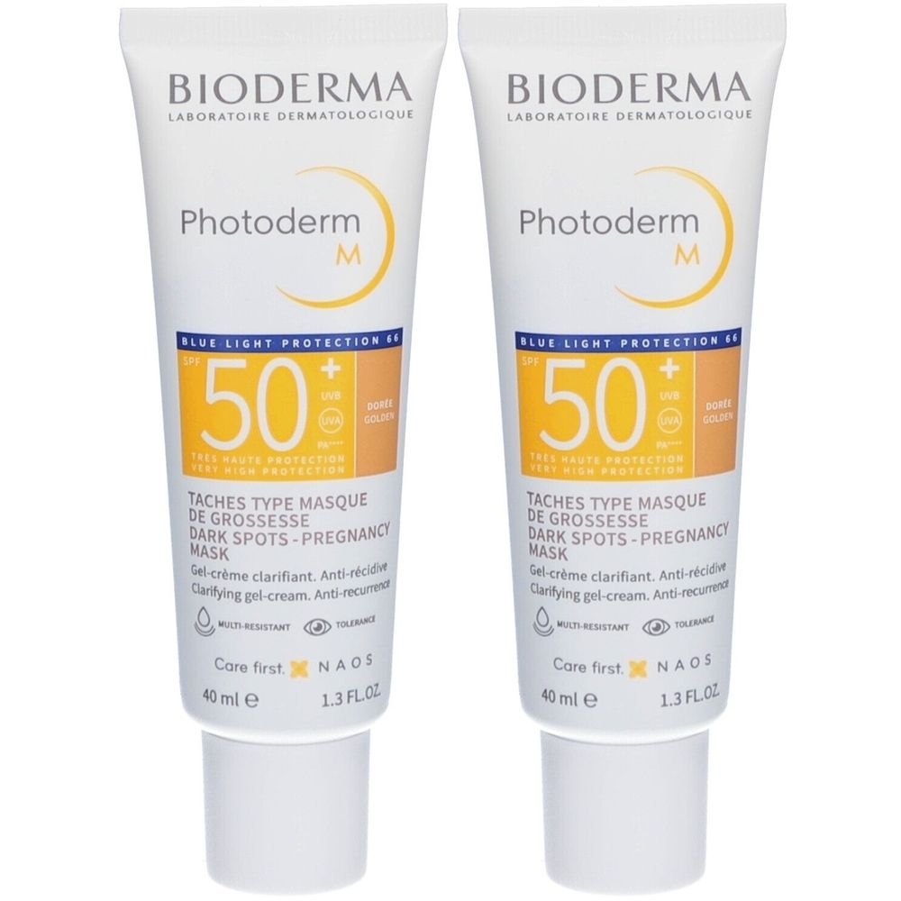 Zwei Tuben BIODERMA Photoderm M. Weiße Tuben mit gelben und braunen Akzenten. Aufschrift: 50+ Sonnenschutz, Dark Spots-Pregnancy Mask.