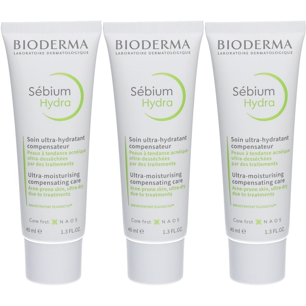 Trois tubes de Bioderma Sébium Hydra. Tubes blancs avec texte et logo vert. Texte: ultra-hydratant compensateur, acne-prone skin.