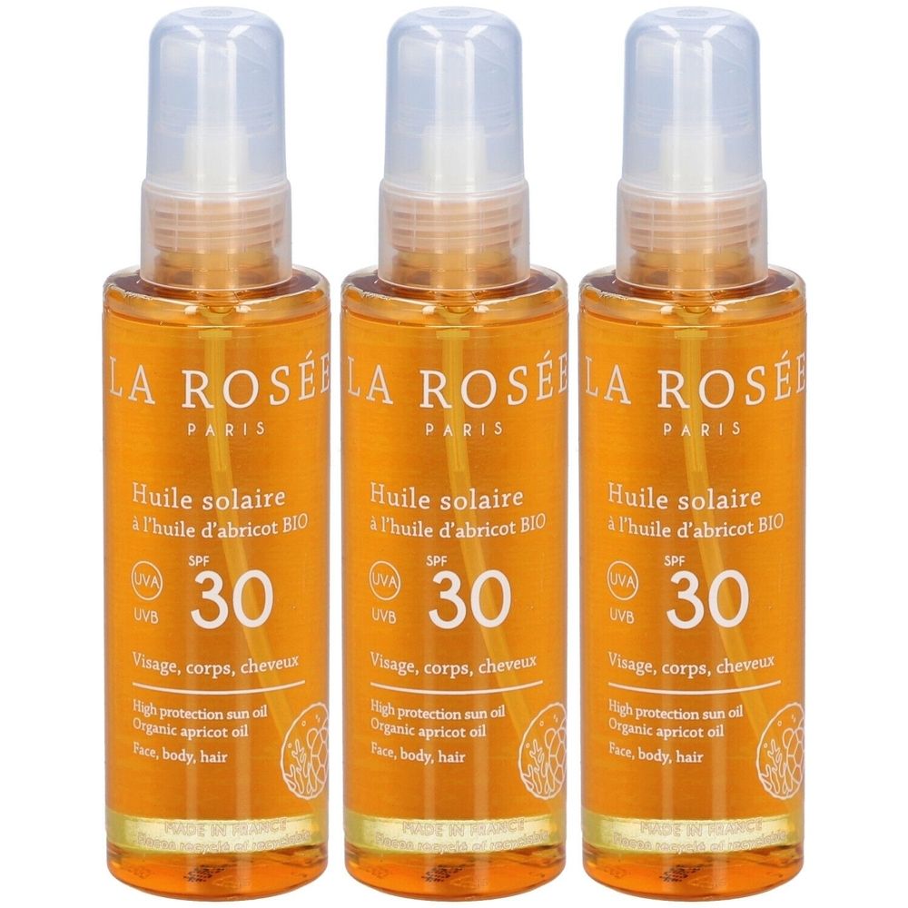 Trois flacons d'huile solaire avec vaporisateur. Inscription : LA ROSÉE, Huile solaire SPF 30. Pour visage, corps et cheveux.