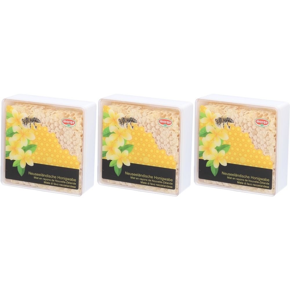 Trois emballages de miel en rayon MORGA. Boîtes blanches avec rayons de miel, fleurs jaunes et texte. Logo MORGA.