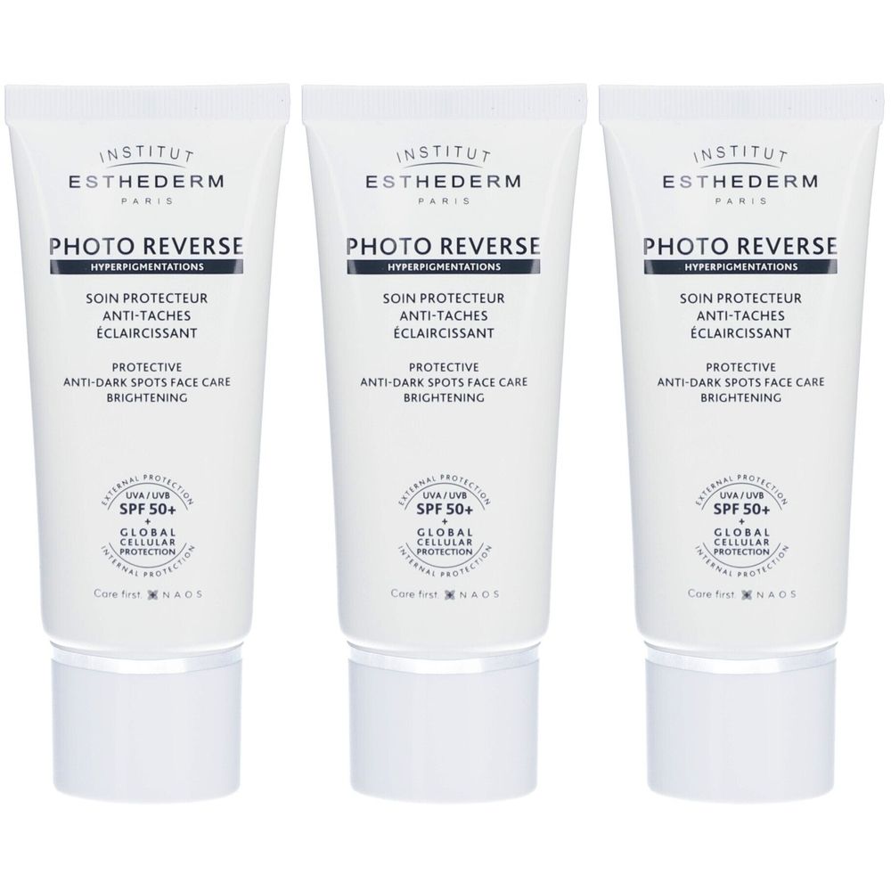 Trois tubes de Photo Reverse SPF 50+ Institut Esthederm. Tubes blancs avec texte et logo. Inscription: Photo Reverse, SPF 50+.