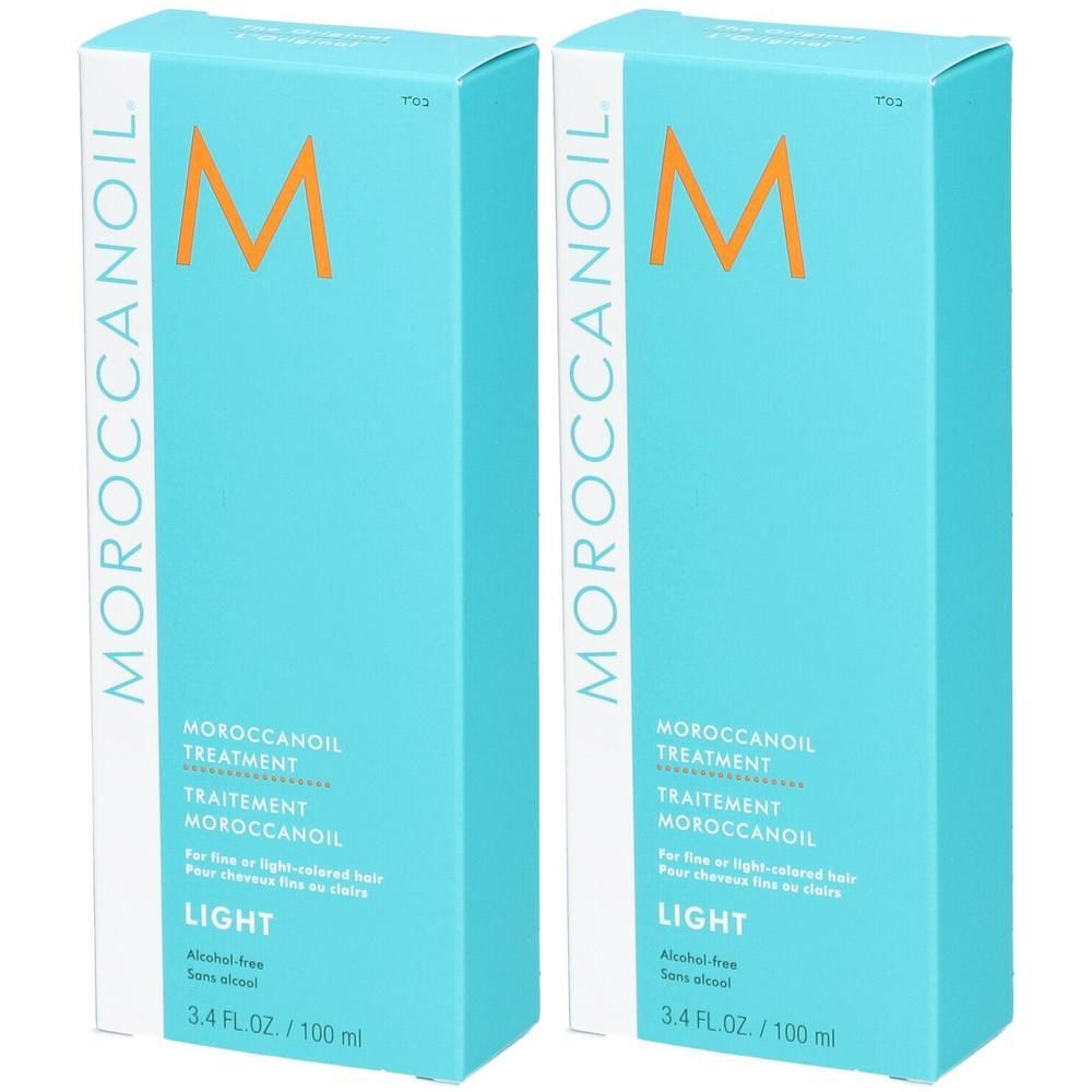 Deux bouteilles de Moroccanoil Treatment Light dans un emballage turquoise avec logo M orange.