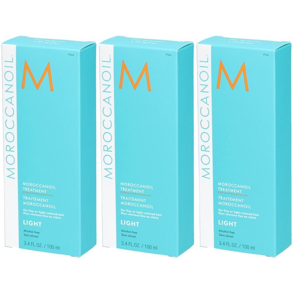 Trois boîtes de Moroccanoil Treatment Light, emballages bleu clair avec logo M orange.