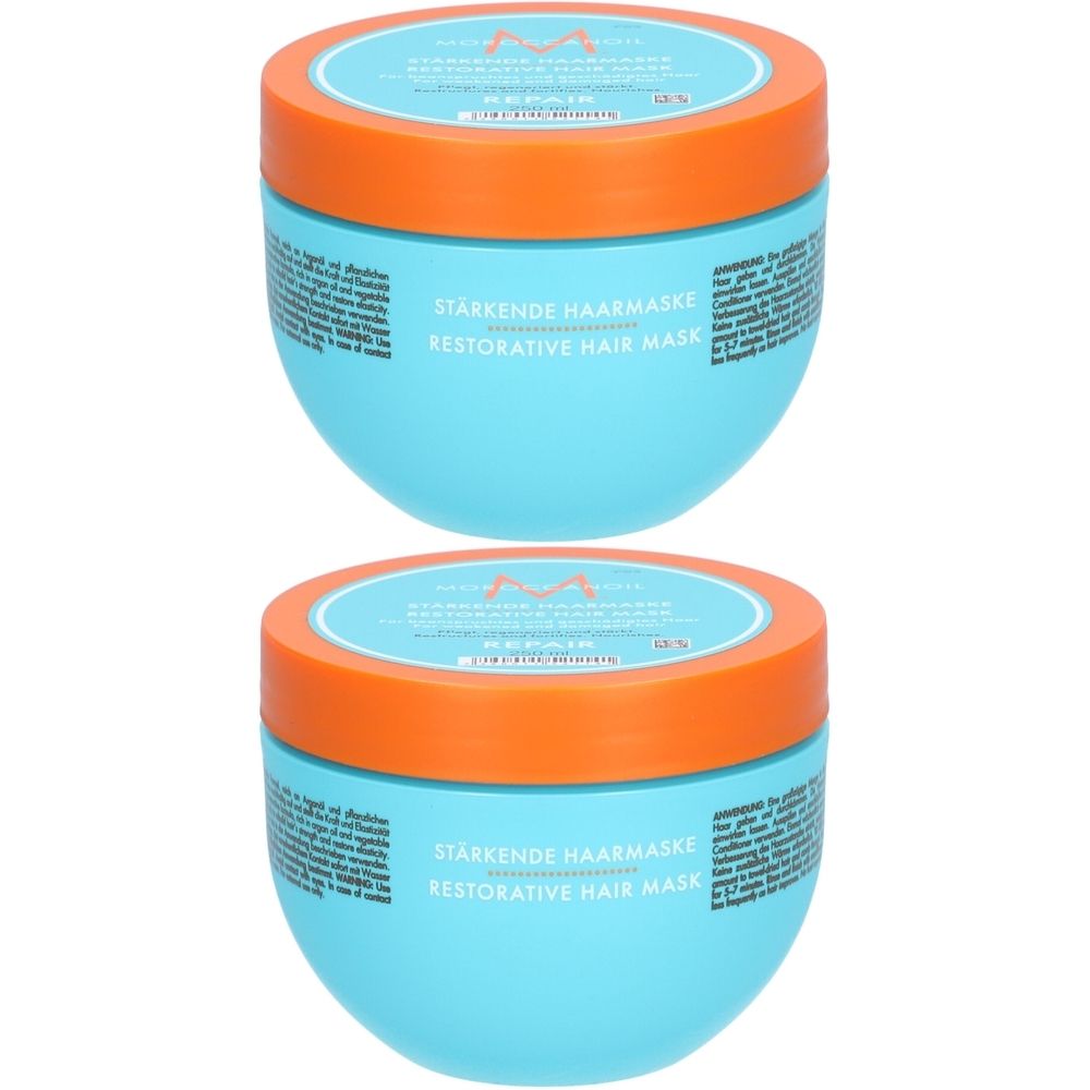 Deux pots bleus avec couvercles orange. Inscription : Stärkende Haarmaske, Restorative Hair Mask. Logo Moroccanoil.