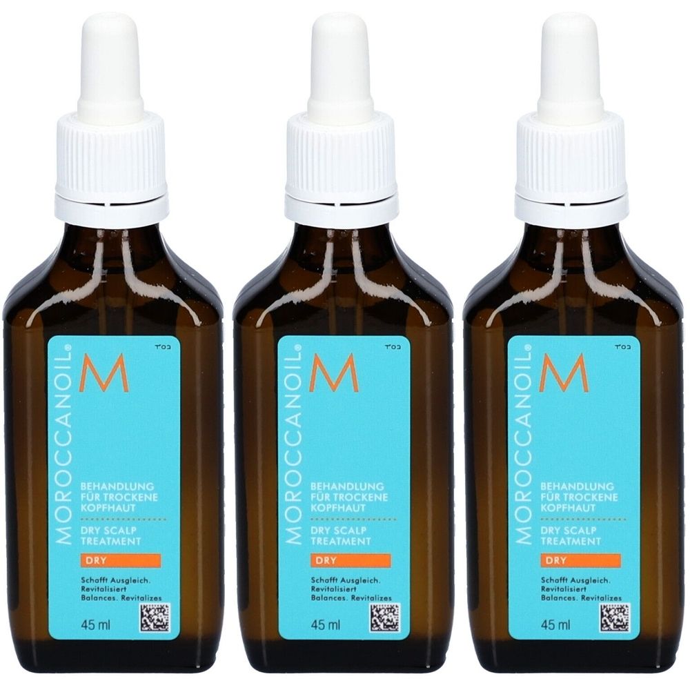 Trois flacons de traitement Moroccanoil pour cuir chevelu sec. Flacons en verre brun avec bouchons blancs et étiquettes bleues avec texte.