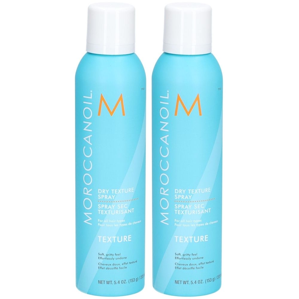Deux flacons de spray bleus avec bouchons blancs. Inscription : Moroccanoil, Dry Texture Spray, Texture. Poids net 5.4 oz (150 g).