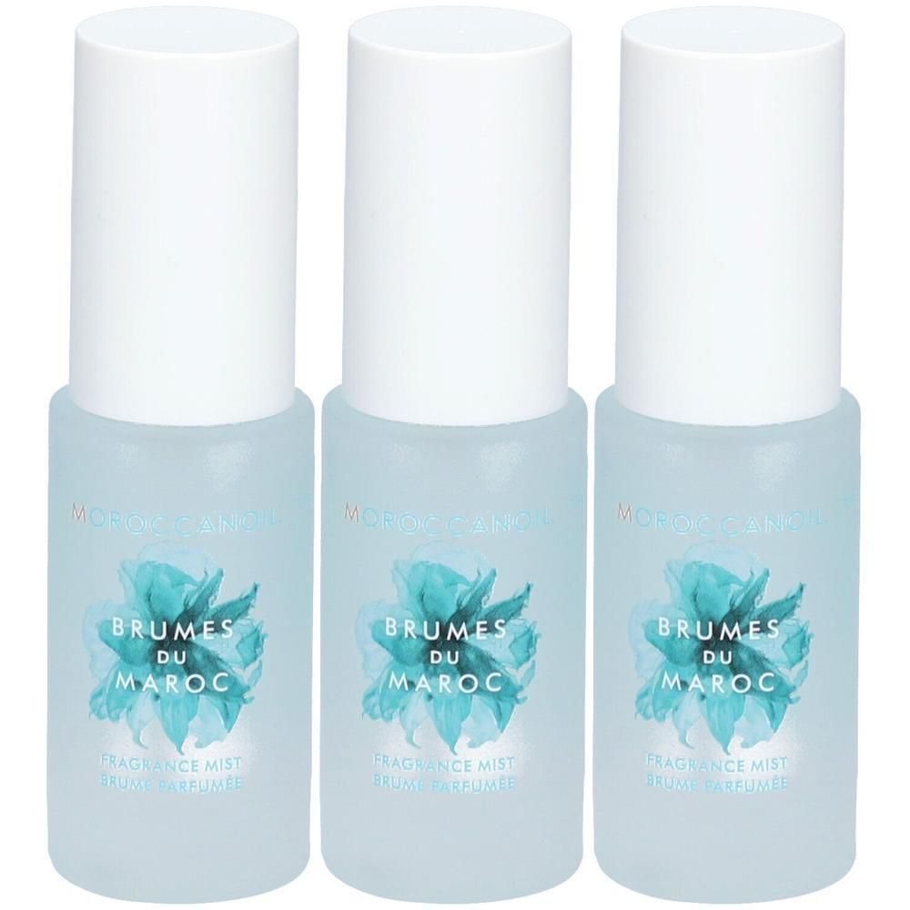 Trois flacons de Moroccanoil Brumes du Maroc avec bouchon blanc et étiquette bleue.