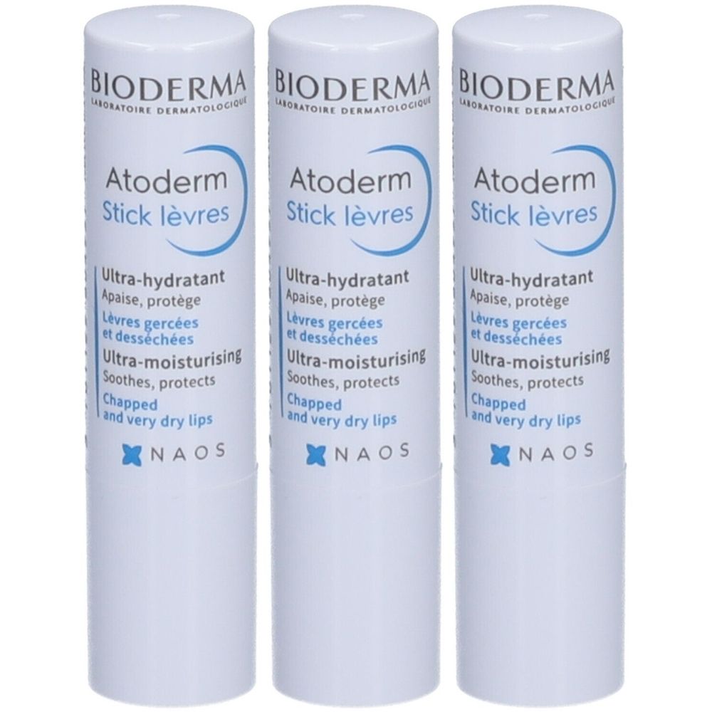 Drei weiße Lippenpflegestifte. Aufschrift: BIODERMA Atoderm Stick lèvres. Text in Französisch und Englisch. NAOS Logo.