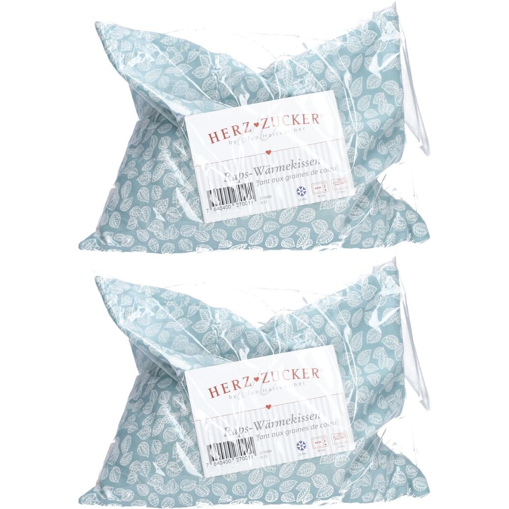 Deux coussins chauffants HERZZUCKER® emballés. Motif bleu clair à feuilles. Étiquette avec informations produit.