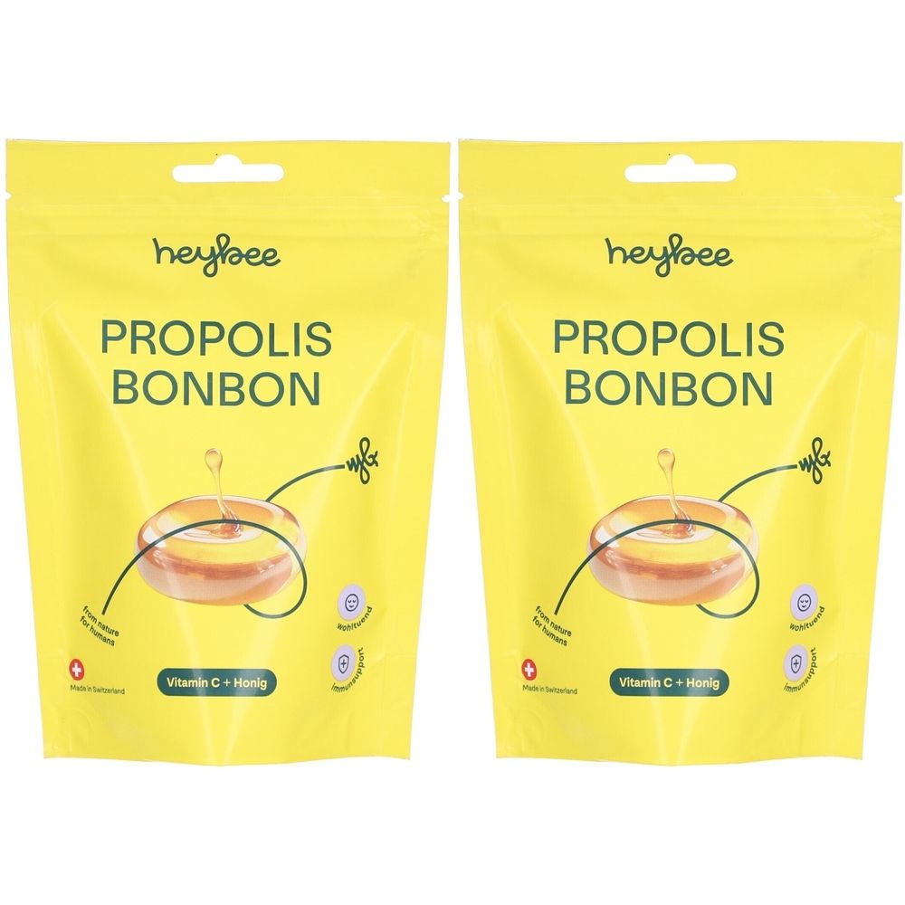 Zwei gelbe Beutel mit "heybee PROPOLIS BONBON". Abbildung eines Bonbons. Text: Vitamin C + Honig. Schweizer Kreuz.