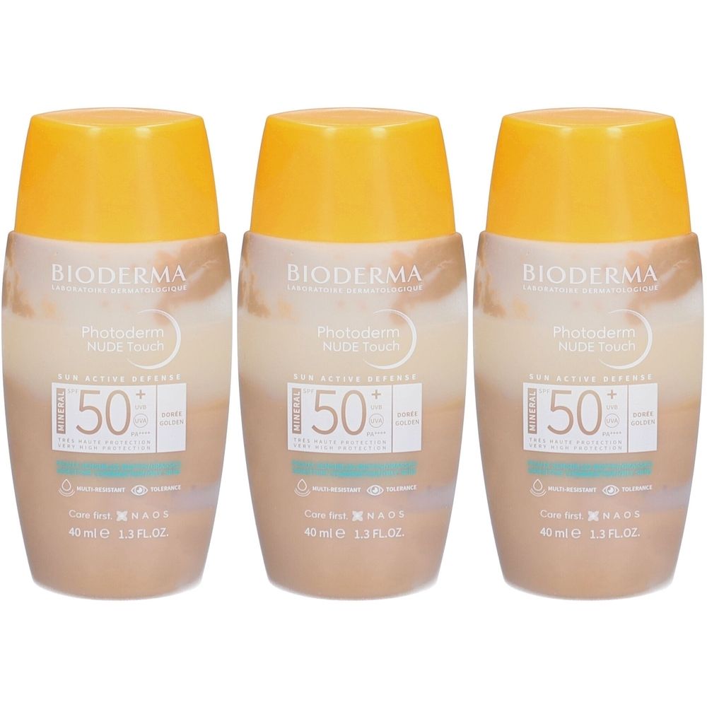 Drei Flaschen BIODERMA Photoderm NUDE Touch Mineral SPF50+ Golden. Beige-farbene Flaschen mit gelben Deckeln. Aufschrift: SPF50+.