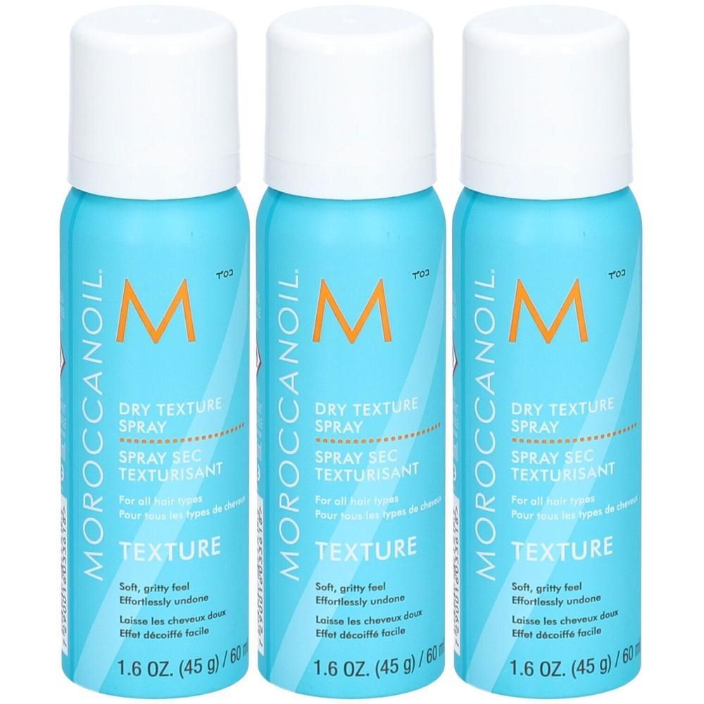 Trois flacons de Moroccanoil Dry Texture Spray turquoise avec bouchon blanc. Texte : DRY TEXTURE SPRAY.