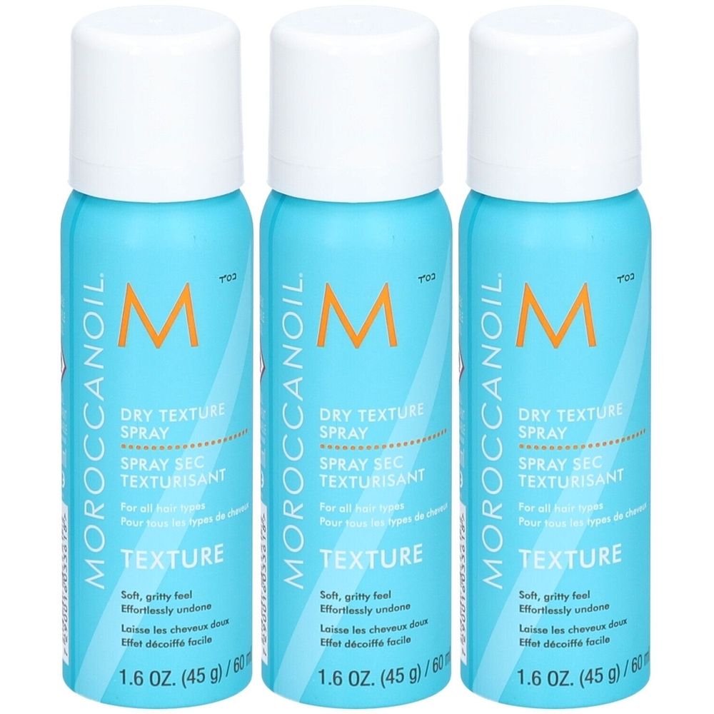 Trois sprays bleus avec bouchons blancs. Inscription: Moroccanoil, Dry Texture Spray, Texture. 1.6 OZ. (45g) / 60 ml.
