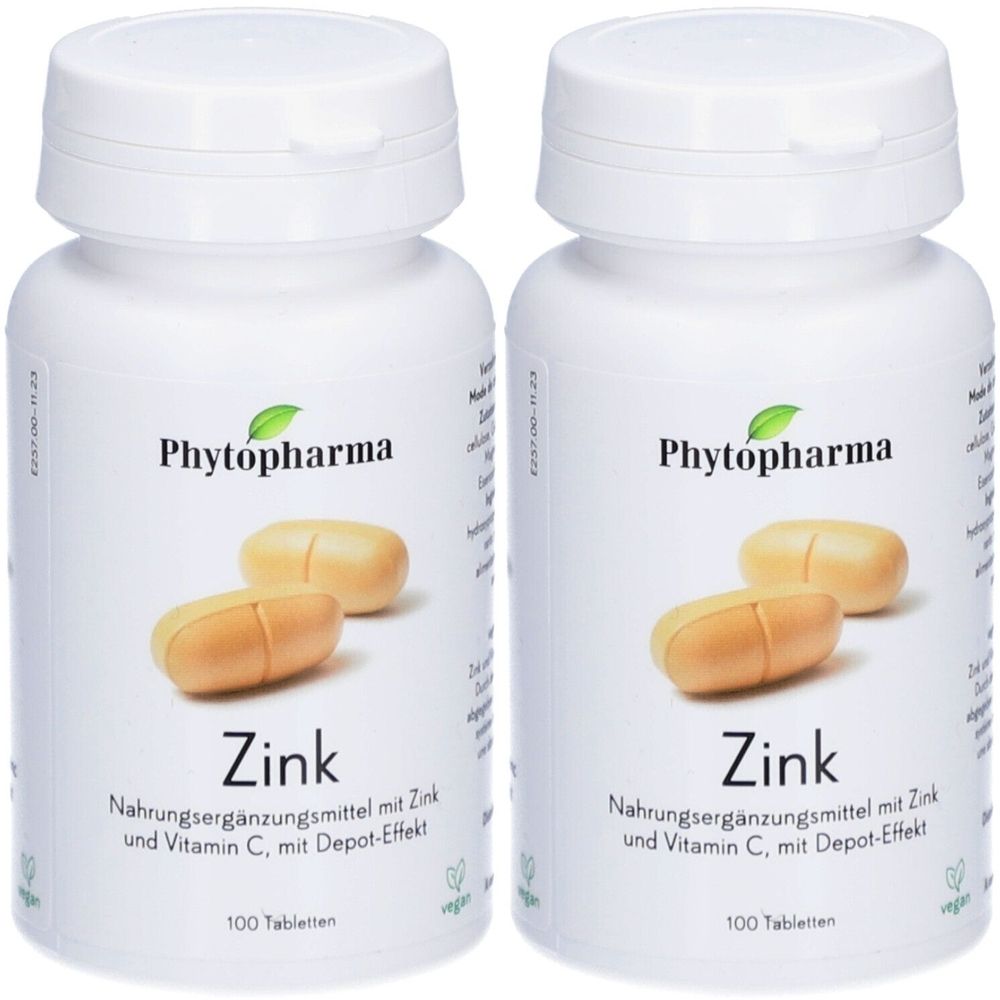 Deux flacons blancs de Zink. Sur chaque flacon, des comprimés sont représentés. Texte : Complément alimentaire avec zinc et vitamine C, avec effet dépôt.