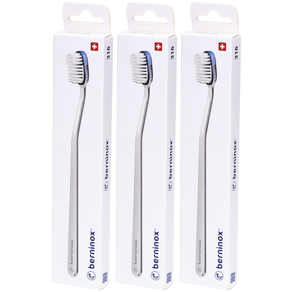 Trois brosses à dents dans des emballages blancs. Les brosses ont un manche argenté et une tête bleue. Le mot "berninox" est visible sur les emballages.