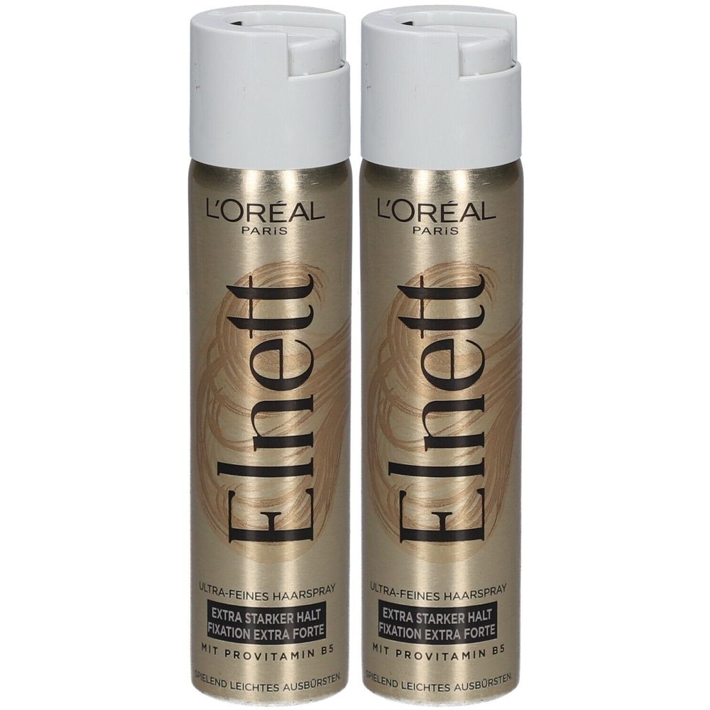 Zwei Haarspray-Flaschen. Goldfarbene Dosen mit weißem Sprühkopf. Aufschrift: L'Oréal Paris, Elnett, Extra starker Halt, mit Provitamin B5.