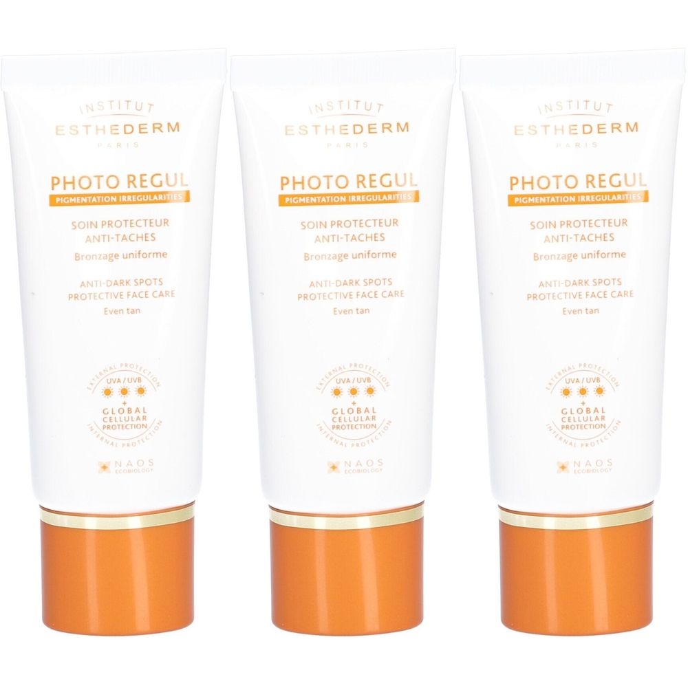 Drei Tuben Esthederm Photo Regul Gesichtscreme. Weiße Tuben mit orangefarbenen Kappen. Aufschrift: Photo Regul, Anti-Taches, Protective Face Care.