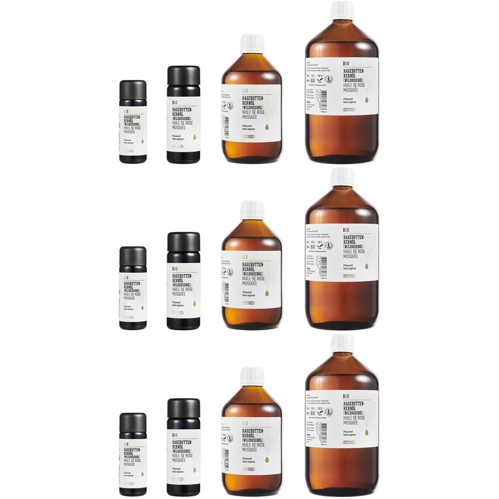 Plusieurs bouteilles et petits flacons. Bouteilles en verre brun avec bouchons blancs. Petits flacons noirs avec bouchons noirs. Étiquettes avec texte.