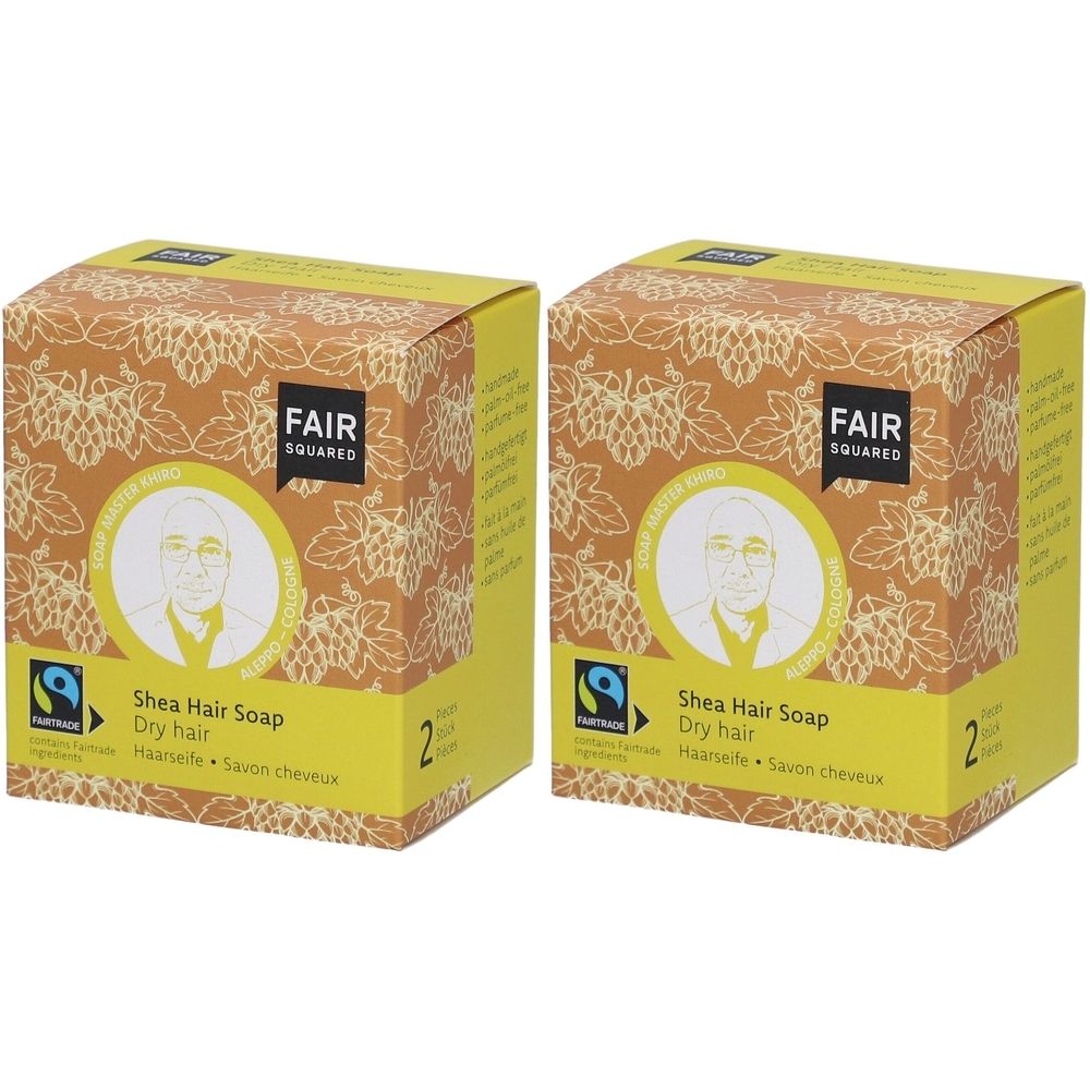 Zwei quadratische Kartons mit FAIR SQUARED Logo. Aufschrift: Shea Hair Soap, Dry hair. Fairtrade-Siegel. Gelb-braunes Design.
