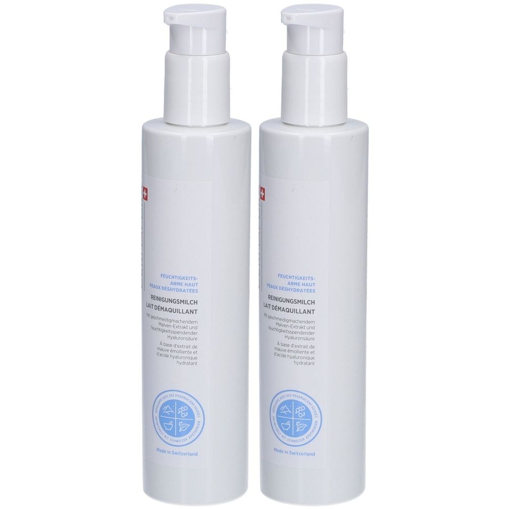 Deux flacons blancs avec pompe. Inscription: Lait démaquillant, Reinigungsmilch. Croix suisse.