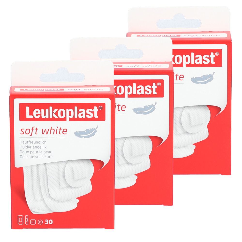 Drei Packungen Leukoplast Soft Strips. Rote Verpackung mit weißem Produkt. Aufschrift: soft white. 30 Stück.