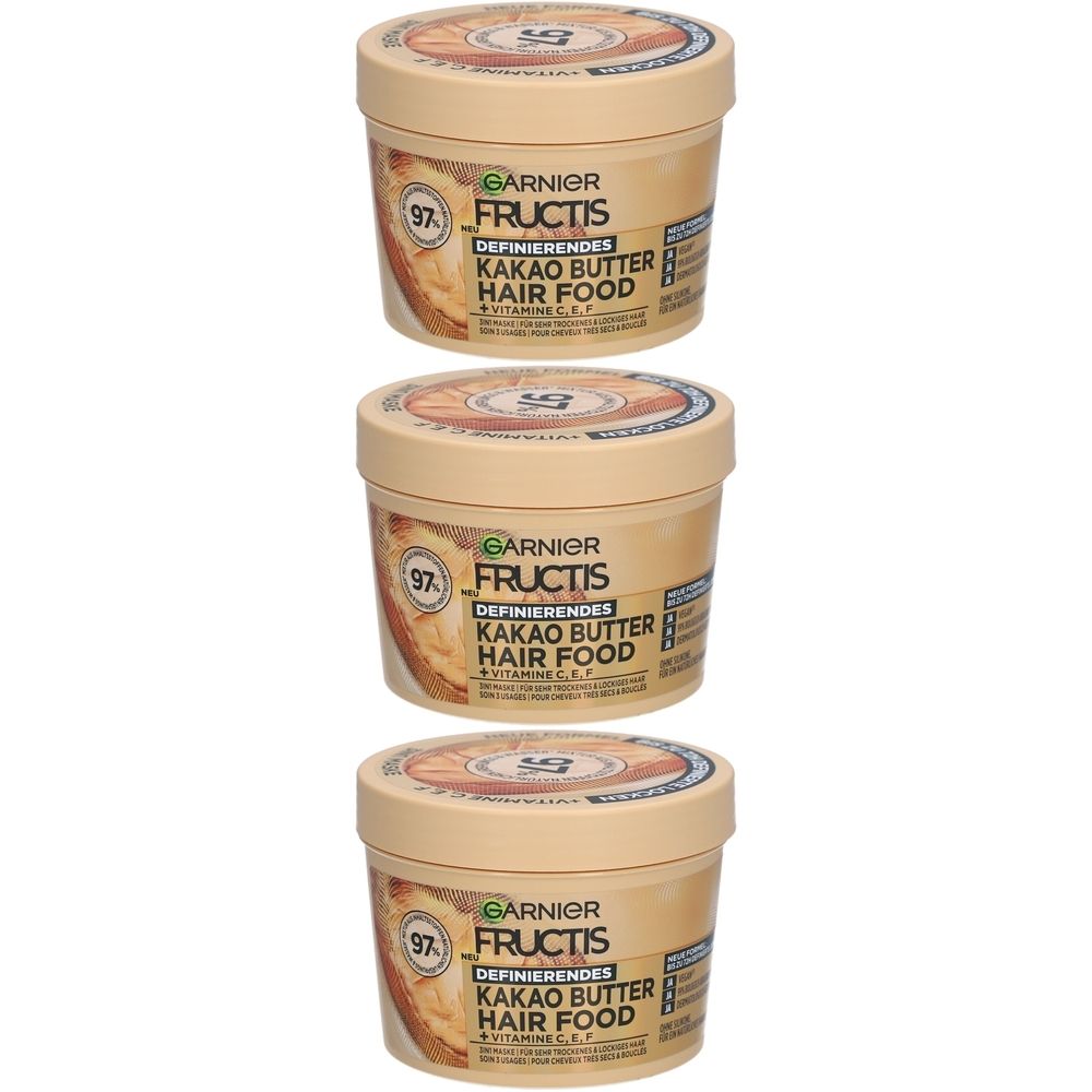 Trois pots crème avec couvercles. Chaque pot porte l'inscription "GARNIER FRUCTIS KAKAO BUTTER HAIR FOOD".