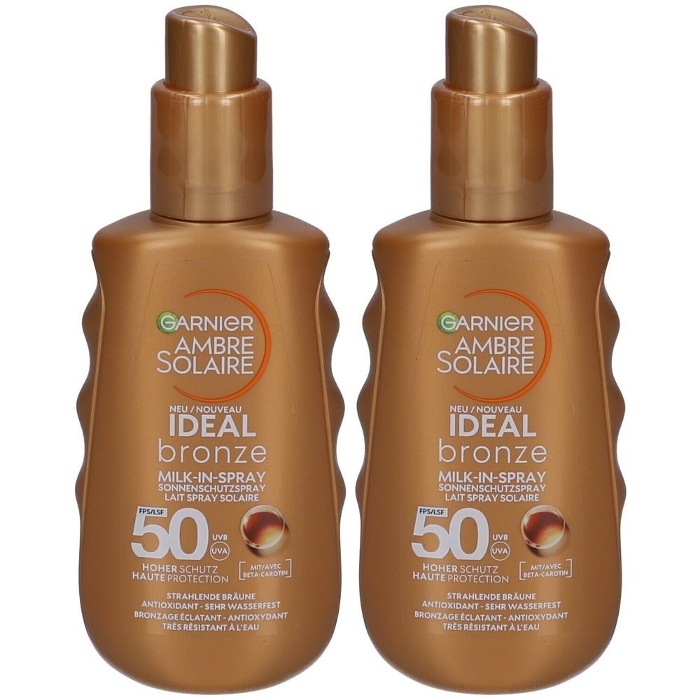 Zwei braune Sprühflaschen. Aufschrift: Garnier Ambre Solaire Ideal Bronze Milk-in-Spray SPF50. Hoher Schutz. Wasserfest.
