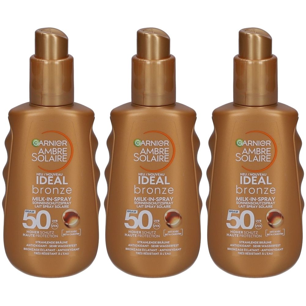 Drei Flaschen Garnier Ambre Solaire Ideal Bronze Sonnenspray SPF50. Braune Flaschen mit goldenen Pumpköpfen. Text: Ideal Bronze, Milk-in-Spray.
