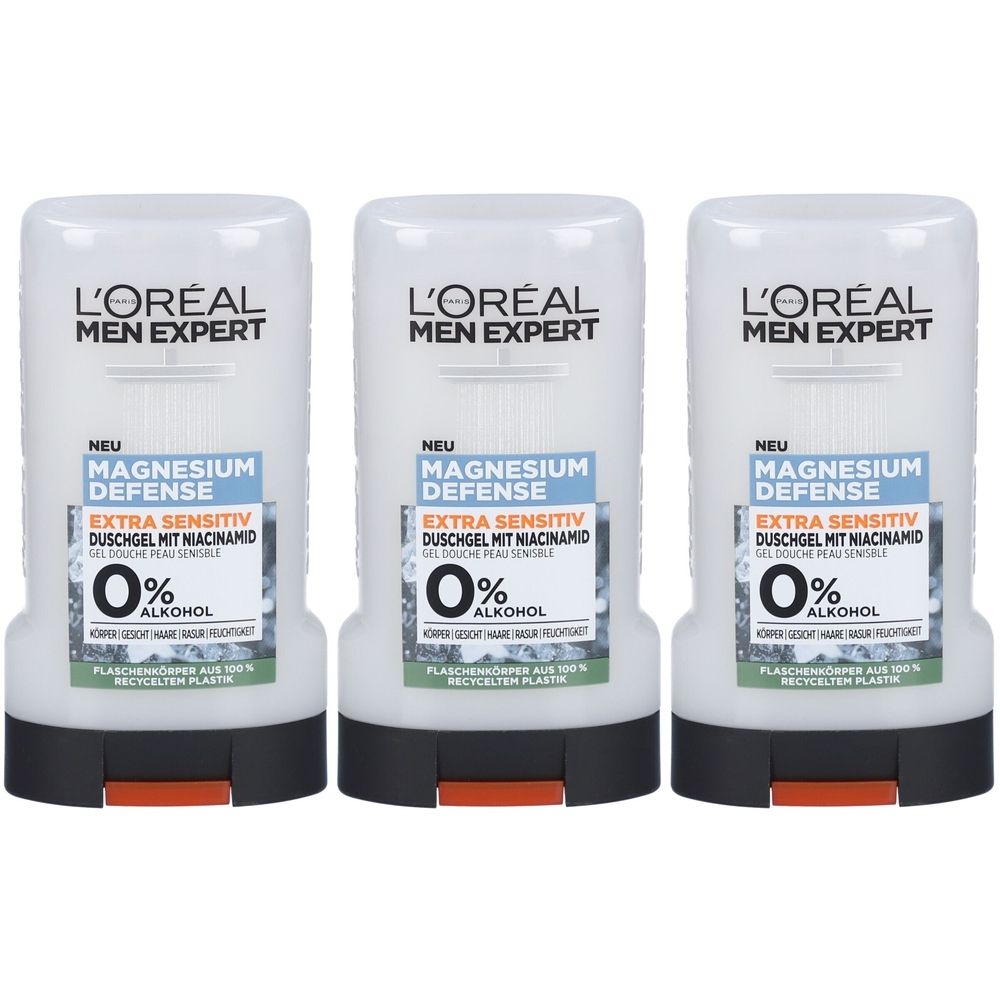 Trois flacons de gel douche L'Oréal Men Expert Magnesium Defense. Flacons blancs avec bouchon noir et fermeture orange. Texte : 0% alcool.