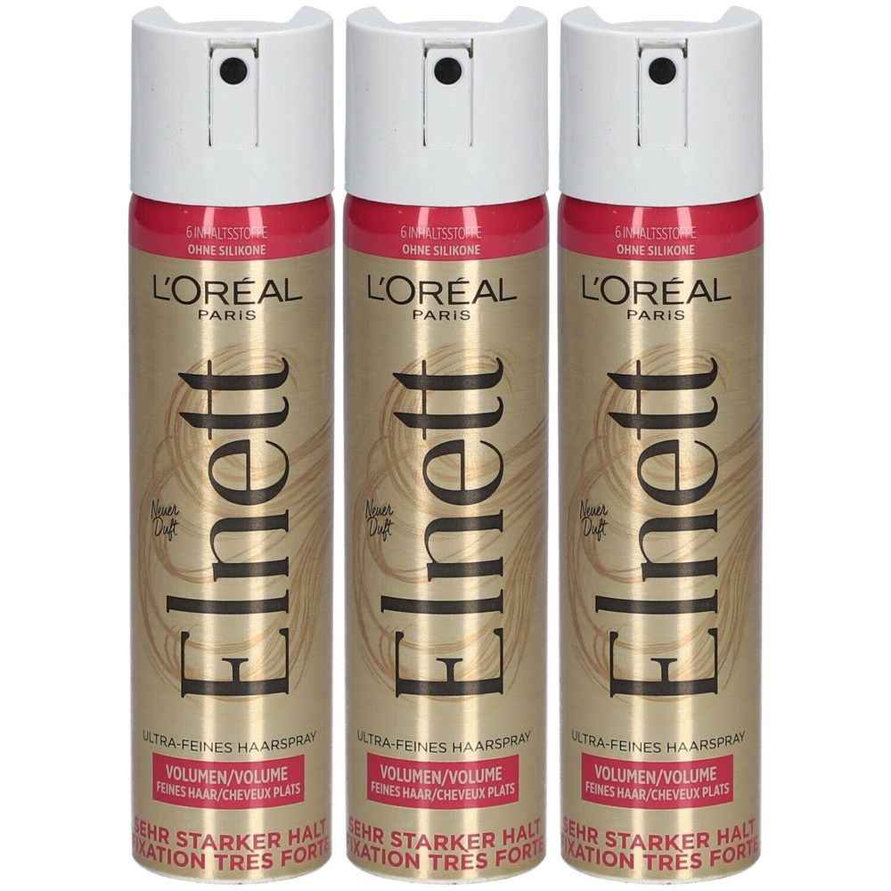 Drei Haarspray-Flaschen. Weißer Sprühkopf, goldene Dose mit roter Schrift. Text: L'Oréal Paris, Elnett, Volumen, ultra-feines Haarspray.