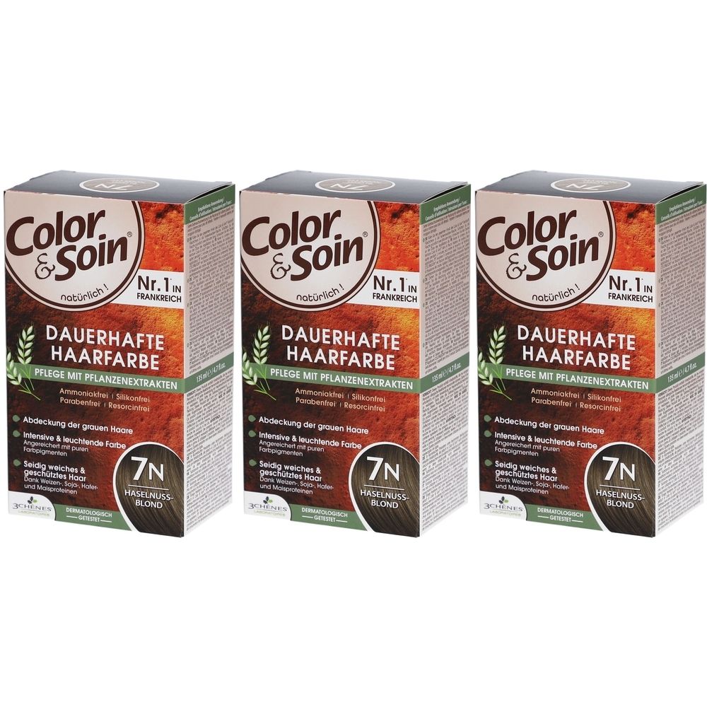 Trois boîtes de coloration Color & Soin®. Inscription: Coloration permanente, 7N Blond noisette. Emballage avec extraits végétaux.