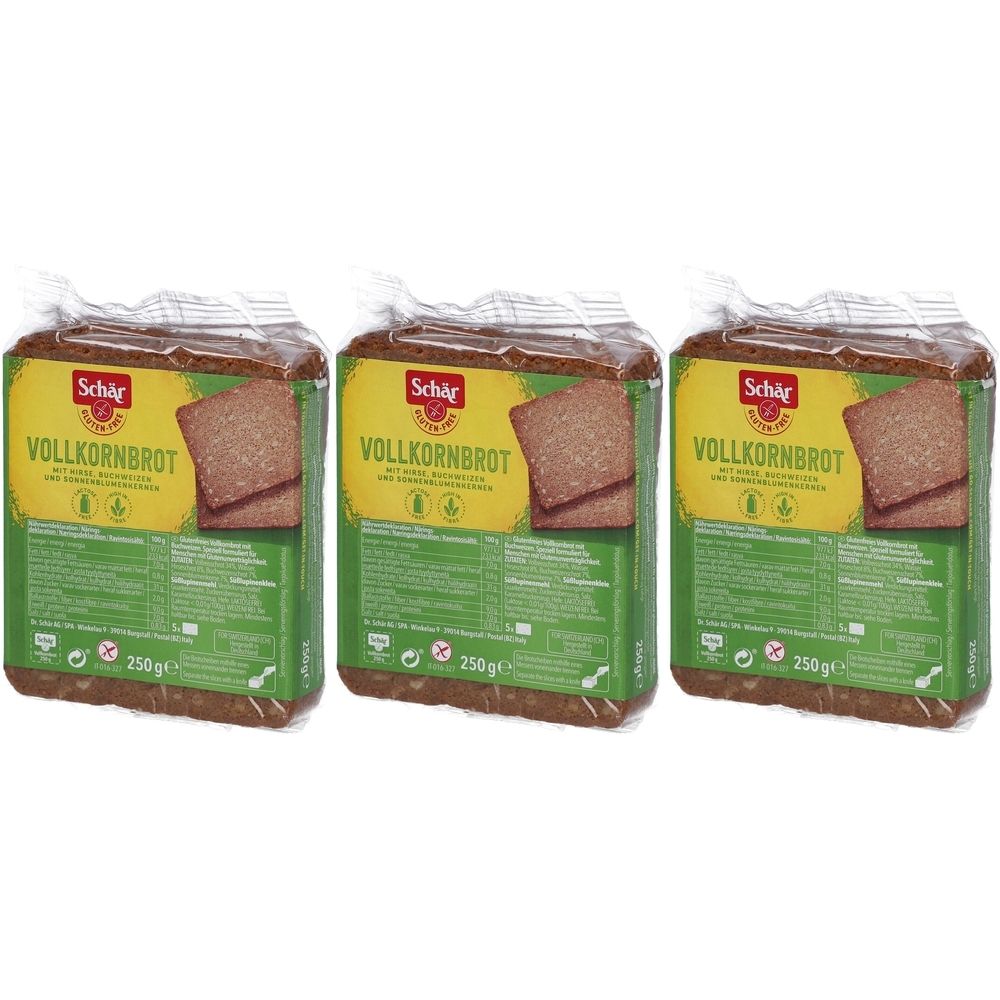 Trois paquets de pain complet Schär. Chaque paquet montre une tranche de pain. Emballage jaune-vert avec informations et logo.