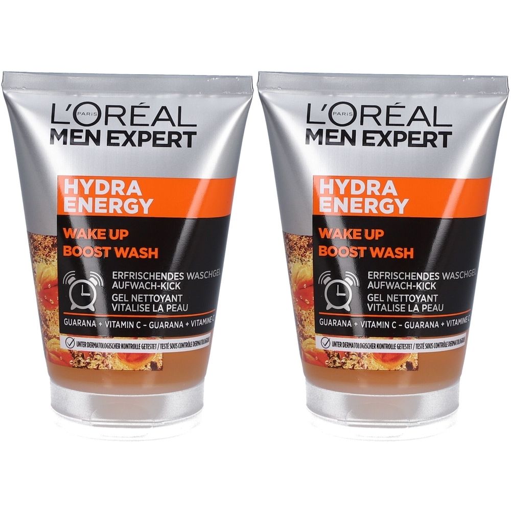 Zwei Tuben L'Oréal Men Expert Hydra Energy. Aufschrift: Wake Up Boost Wash, Gel Nettoyant. Silberne, orange und schwarze Verpackung.