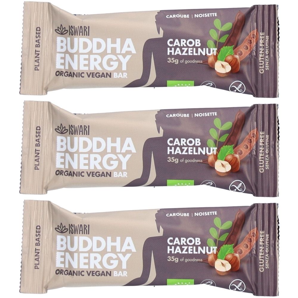 Drei ISWARI Buddha Energy Riegel. Aufschrift: Carob Hazelnut, 35g, glutenfrei. Verpackung in Beige und Lila mit Logo und Produktnamen.