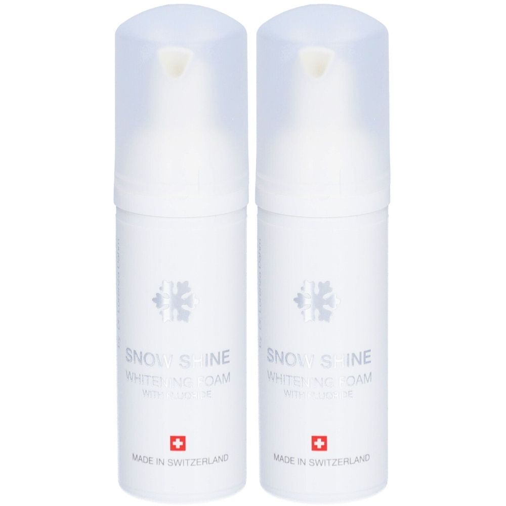 Deux flacons blancs avec couvercles transparents. Inscription: Snow Shine Whitening Foam avec fluorure. Croix suisse. Fabriqué en Suisse.