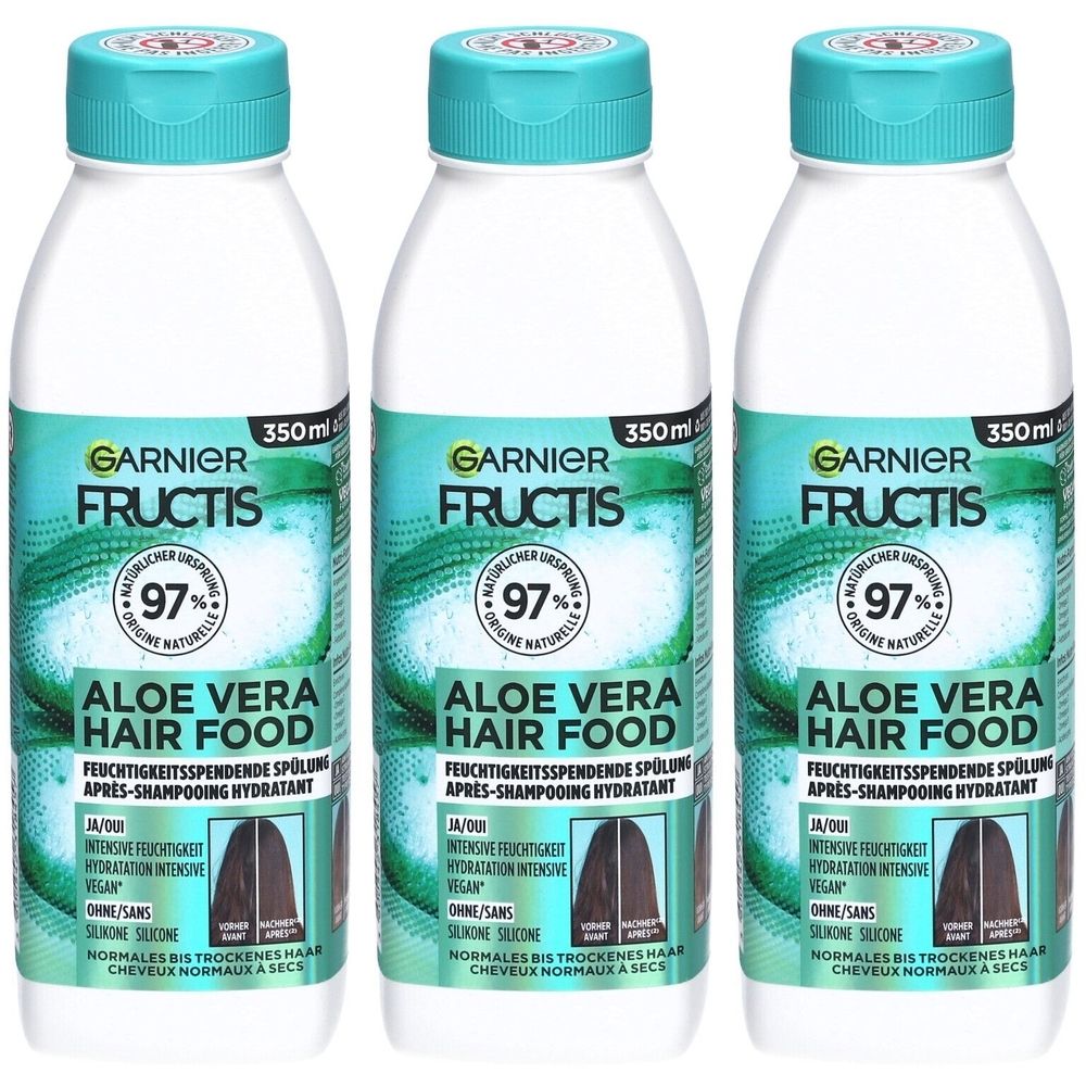 Trois bouteilles de Garnier Fructis Aloe Vera Hair Food. Bouteilles blanches avec bouchons et étiquettes turquoise. Texte : 97% d'origine naturelle.