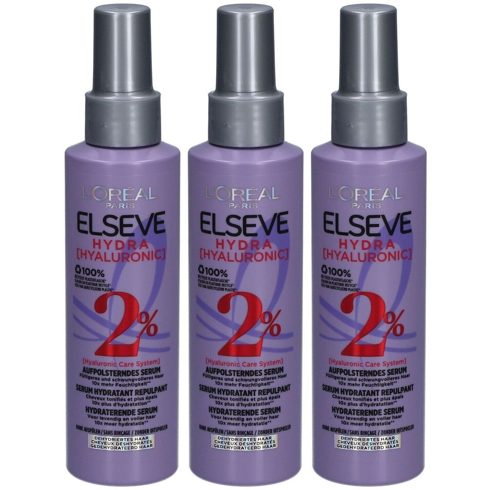 Drei Flaschen L'Oréal Paris Elseve Hydra Hyaluronic Serum. Lila Flaschen mit silbernen Sprühköpfen. Text: Elseve, Hydra Hyaluronic, 2%.