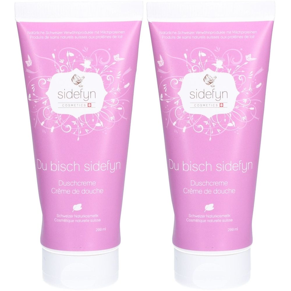 Deux tubes de crème de douche roses avec impression blanche. Inscription : "sidefyn", "Du bisch sidefyn", "Duschcreme", "Crème de douche".