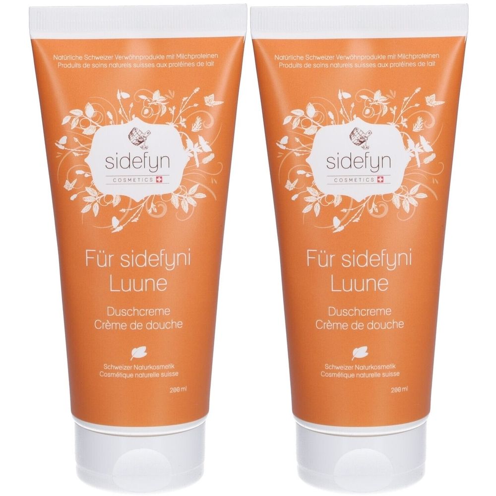 Deux tubes de crème de douche orange avec texte blanc et motifs floraux. Inscription : sidefyn, Für sidefyni Luune, Crème de douche.