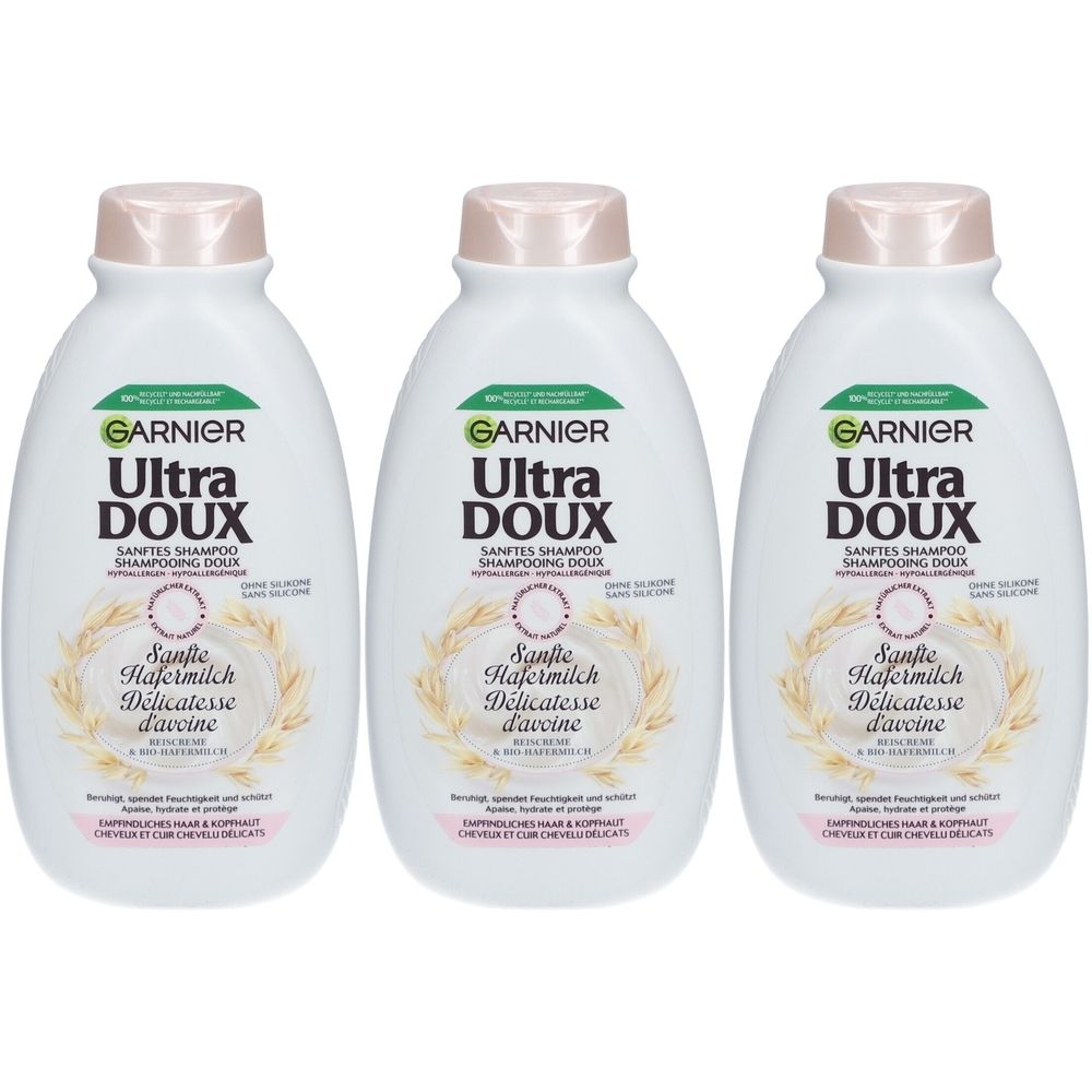Drei weiße Shampoo-Flaschen mit rosafarbenen Deckeln. Auf jeder Flasche steht "GARNIER Ultra DOUX" und "Sanfte Hafermilch Délicatesse d'avoine".