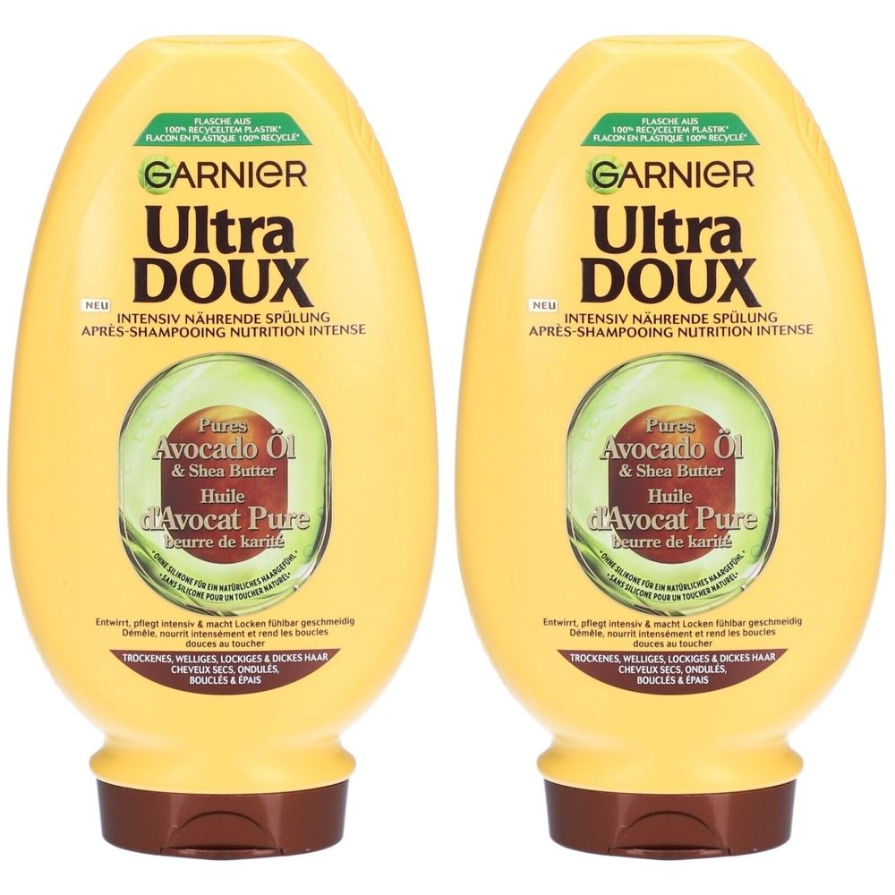 Deux flacons jaunes GARNIER Ultra Doux. Inscription: Après-shampooing nutrition intense, huile d'avocat pure et beurre de karité. Pour cheveux secs, ondulés.