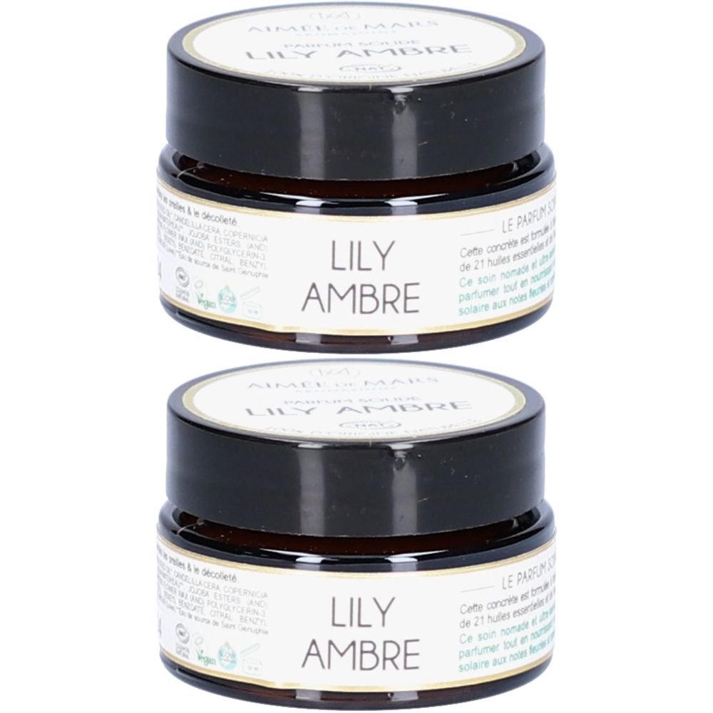 Zwei kleine, runde Tiegel mit schwarzem Deckel. Auf dem Etikett steht "LILY AMBRE".
