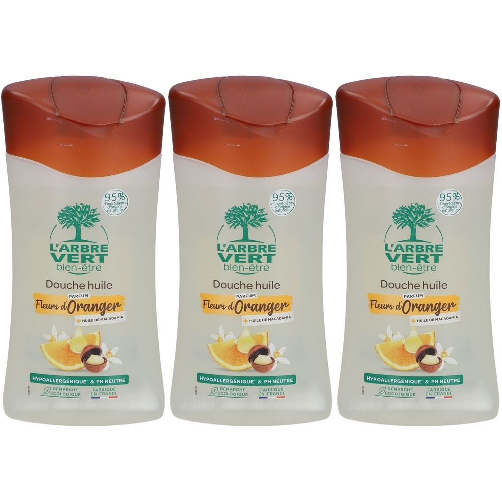Trois flacons de douche huile. Chaque flacon a un bouchon marron et une étiquette avec du texte et des illustrations. Le produit est de L'ARBRE VERT.