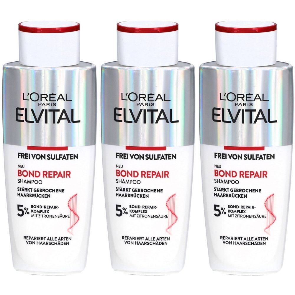 Trois flacons de shampooing L'Oréal Paris Elvital Bond Repair. Flacons blancs et argentés avec texte rouge. Contient 5% de complexe Bond Repair.