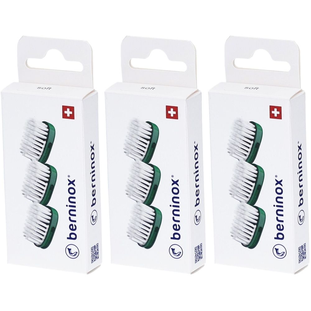 Trois boîtes de rechange pour têtes de brosse. Chaque boîte montre trois têtes de brosse avec des poils blancs et des supports verts. Croix suisse.